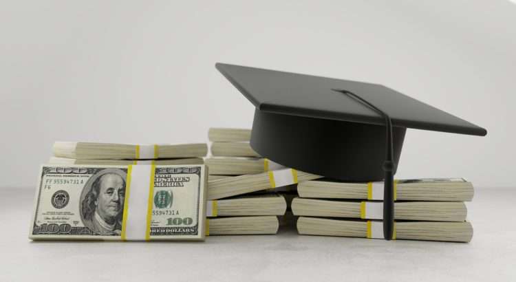 Student Loans -graduation cap sitting on stacks of cash